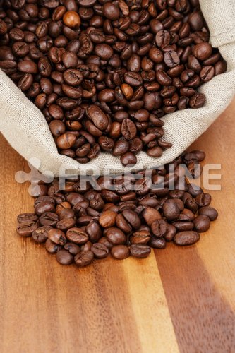 Roated Coffee Beans Spill Out Of The Bag