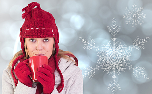 유토이미지 Composite image of happy blonde in winter clothes holding mug