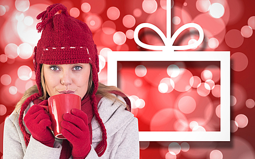 유토이미지 Composite image of happy blonde in winter clothes holding mug