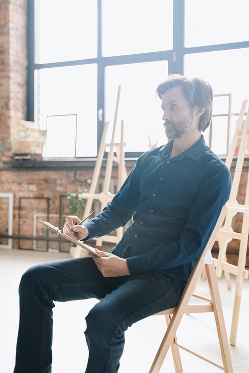 Warm Toned Full Length Portrait Of Pensive Mature Man Sitting