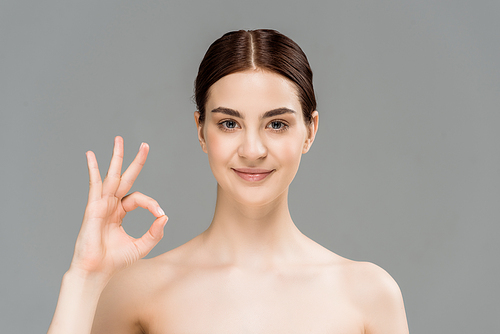 유토이미지 cheerful naked woman showing ok sign isolated on grey