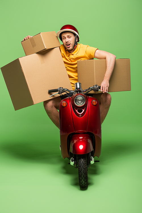 Exhausted Delivery Man In Yellow Uniform On Scooter With Boxes