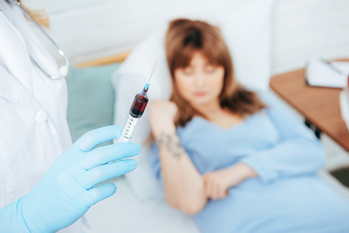 Cropped View Of Doctor Holding Syringe With Blood Sample And