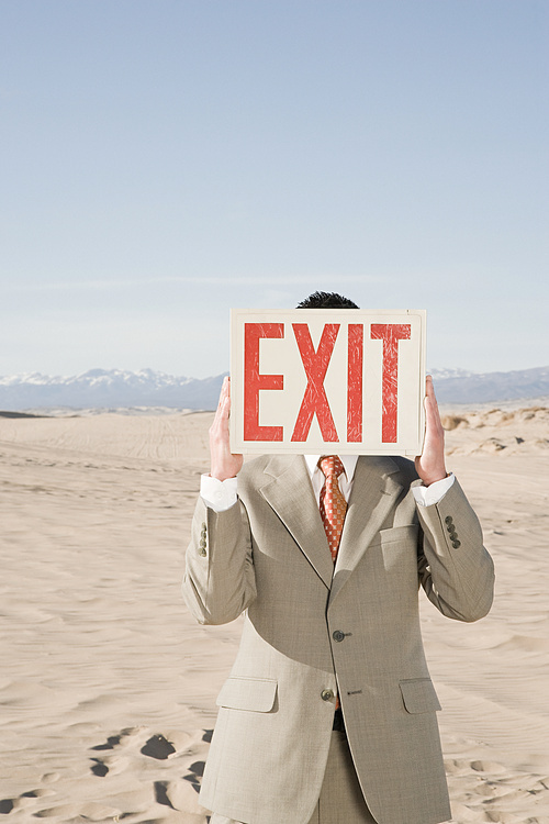 Man in desert with exit sign