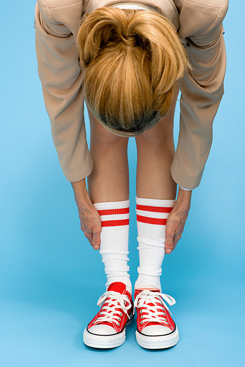 Woman in baseball boots stretching