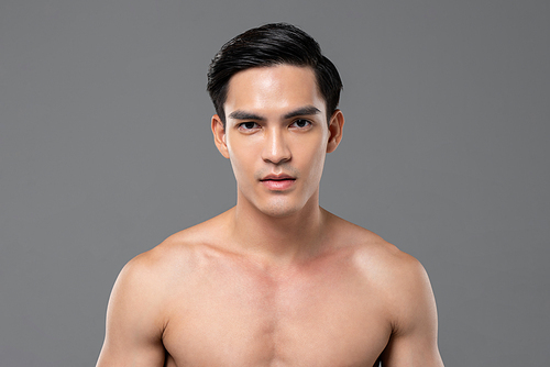 Young shirtless handsome Southeast Asian man with healthy glowing clear face skin for men beauty and skincare concepts