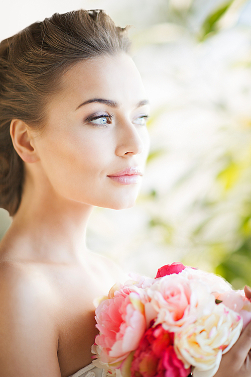 lovely bride with bouquet of flowers indoors