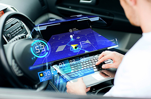 transport, modern technology and people concept - man using navigation system on laptop computer in car