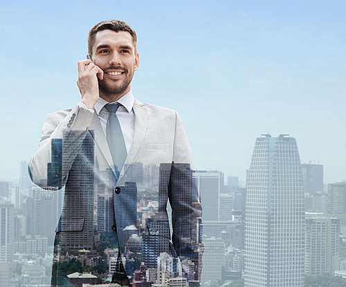 business, technology, communication and people concept - smiling businessman with smartphone talking over city background