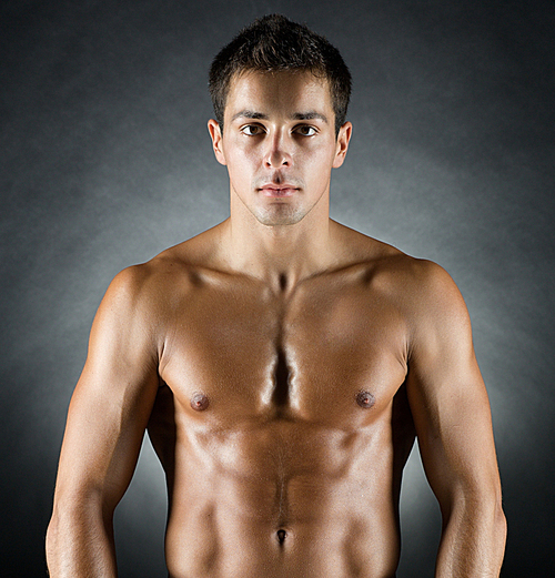 sport, bodybuilding, strength and people concept - young man standing over black background