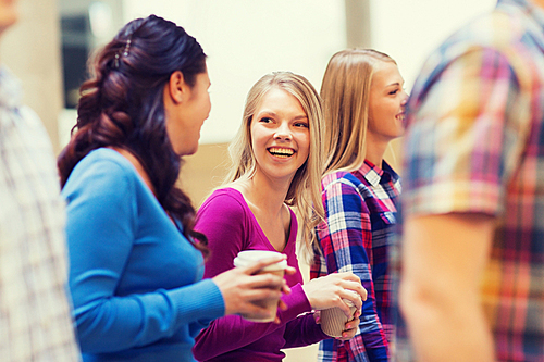 education, high school, friendship, drinks and people concept - group of smiling students with paper coffee cups