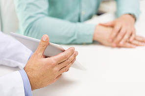 medicine, health care, people, prostate cancer and technology concept - close up of f male doctor and patient hands with tablet pc computer