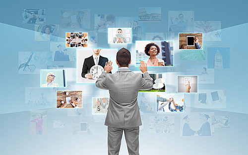 business, people, communication, technology and connection concept - businessman working with images on virtual screen over blue background from back
