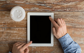 business, education, people and technology concept - close up of male hands with tablet pc computer and coffee paper cup on table