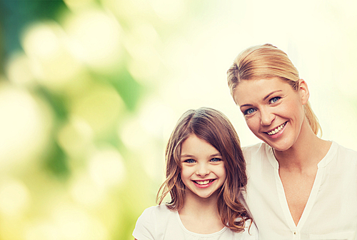 family, childhood, happiness, ecology and people - smiling mother and little girl over green background