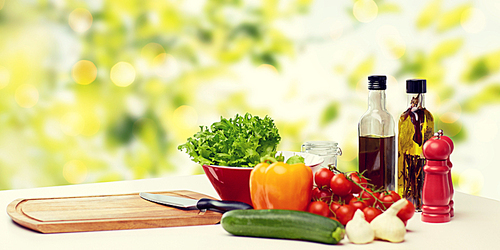 cooking, still life, food and healthy eating concept - fresh ripe vegetables, spices and kitchenware on table over green background