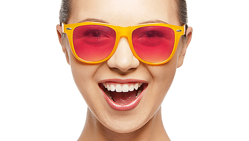 happiness and people concept - portrait of happy teenage girl in shades