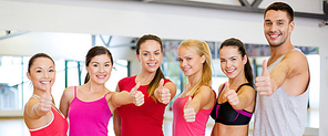 fitness, sport, training, gym and lifestyle concept - group of happy people in the gym showing thumbs up