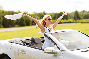 transport, leisure, road trip and people concept - happy man and woman driving in cabriolet car outdoors