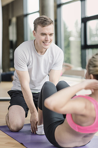 sport, fitness, lifestyle and people concept - smiling woman with male personal trainer exercising in gym