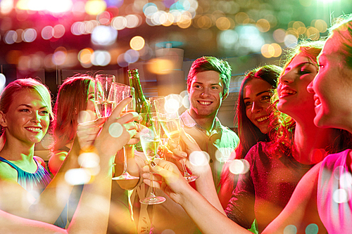 party, holidays, celebration, nightlife and people concept - smiling friends clinking glasses of champagne and beer in club