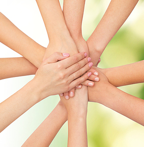 healthcare, people, gesture and medicine concept - close up of women hands on top of each other over green background