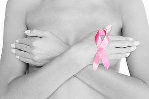 health and medicine concept - naked woman with breast cancer awareness ribbon