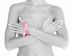 health and medicine concept - naked woman with breast cancer awareness ribbon