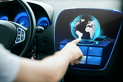 transport, modern technology and people concept - male hand pointing finger to world globe on monitor of car control panel