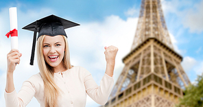 education, school, knowledge, graduation and people concept - happy student girl or woman in trencher cap with diploma certificate over paris eiffel tower background