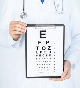 healthcare, medicine and vision concept - male ophthalmologist with eye chart