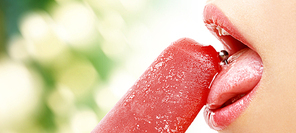 people, sexual and erotic concept - close up of woman mouth with pierced tongue licking fruit ice cream over green natural background