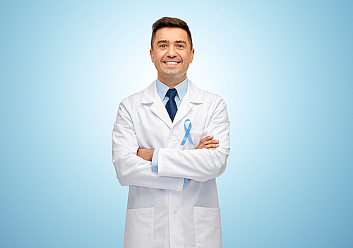 healthcare, profession, people and medicine concept - smiling male doctor in white coat with sky blue prostate cancer awareness ribbon
