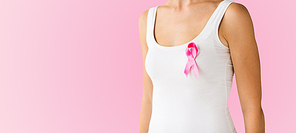 healthcare, people and medicine concept - close up of woman in white shirt with pink cancer awareness ribbon