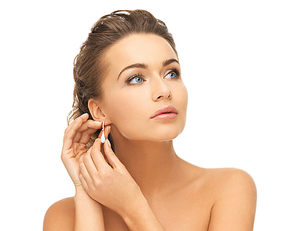 beauty and jewelry concept - beautiful woman wearing shiny diamond earrings