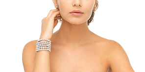 beautiful woman wearing pearl earrings and bracelet