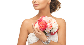 close up of young woman with bouquet of flowers.