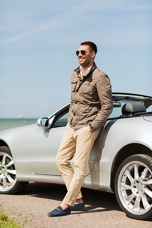 auto business, transport, leisure and people concept - happy man near cabriolet car outdoors