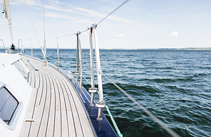 vacation, travel, cruise and leisure concept - close up of sailboat or sailing yacht deck and sea