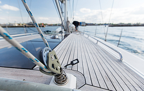 vacation, travel, cruise and leisure concept - close up of sailboat winch or yacht deck sailing on sea