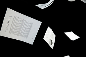 securities, documents, finances and statistics concept - business papers falling down over black background