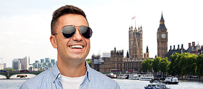 travel, tourism and people concept - face of smiling middle aged latin man in shirt and sunglasses london city background