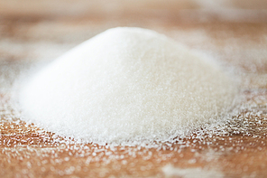food, junk-food, cooking and unhealthy eating concept - close up of white sugar heap on wooden table