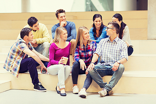 education, high school, friendship, drinks and people concept - group of smiling students with paper coffee cups