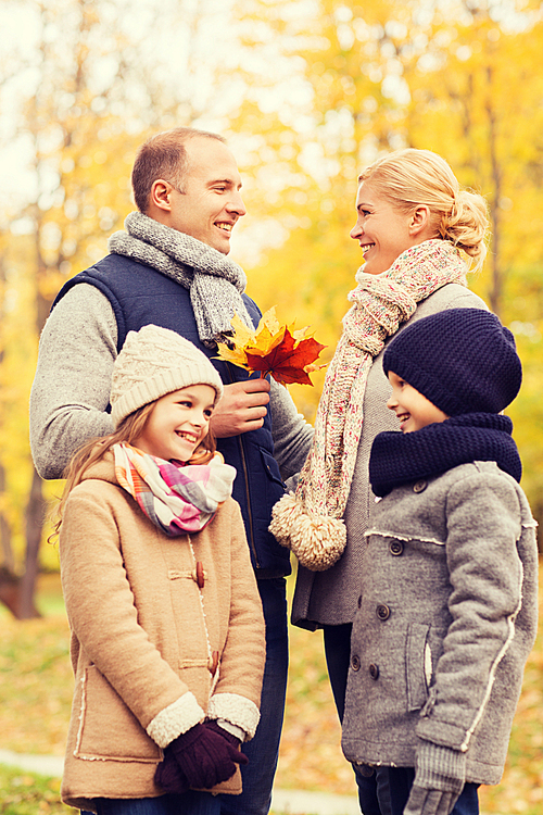 family, childhood, season and people concept - happy family in autumn park