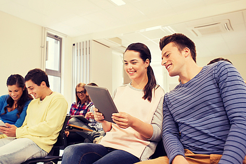 education, high school, teamwork and people concept - group of smiling students with tablet pc computers making photo or video in lecture hall