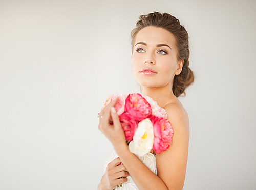 close up of young woman with bouquet of flowers.