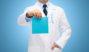 healthcare, advertisement, people and medicine concept - close up of male doctor in white coat with sky blue prostate cancer awareness ribbon holding blank paper
