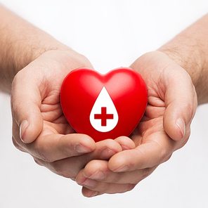 healthcare, medicine and blood donation concept - male hands holding red heart with donor sign