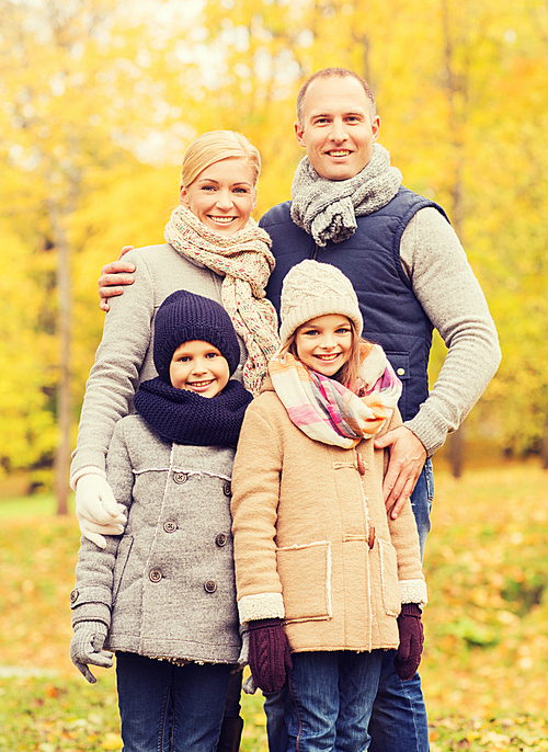 family, childhood, season and people concept - happy family in autumn park